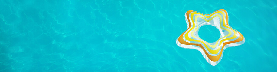 Star shaped inflatable ring floating in swimming pool on sunny day, above view, space for text....