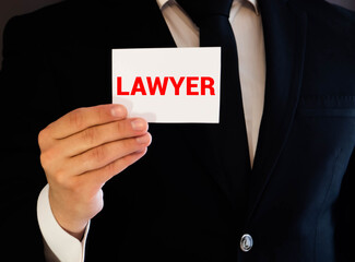 a man in his desk with a nameplate in front of him with the word lawyer written in it