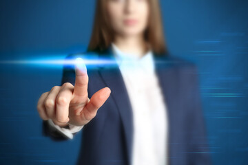 Woman pressing button on virtual screen, closeup
