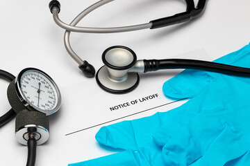 Layoff notice, medical equipment, gloves and stethoscope. Concept of hospital and medical industry...