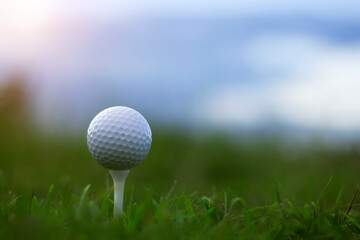 golf ball on tee in a beautiful golf course with morning sunshine