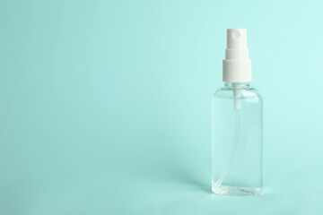 Antiseptic spray on light blue background. Space for text
