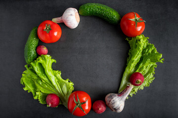 Fresh vegetables on a dark background. The concept of healthy nutrition and diet.