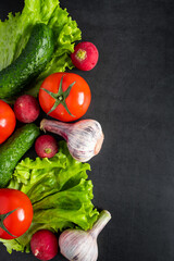 Fresh vegetables on a dark background. The concept of healthy nutrition and diet.