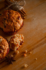 Homemade muffins with raisins. Christmas baking on a wooden background.