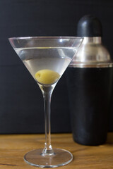 Martini glasses and cocktail shaker on wooden table