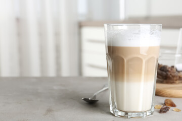 Delicious latte macchiato on grey table indoors, space for text