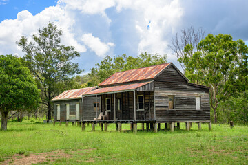 disused homestead in the middle of a green field in Kroombit Tops National Park, Queensland