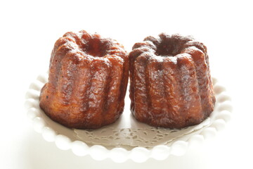 French confectionery, Canele sweet dessert on dish with copy space