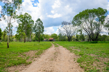 disused homestead in the middle of a green field in Kroombit Tops National Park, Queensland