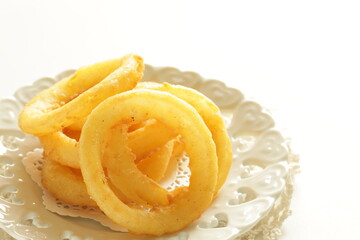 Fast food, onion rings on dish for unhealthy food