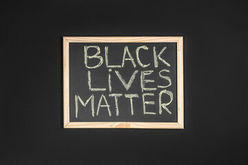 slogan black lives matter written by hand on the chalkboard. protest against racism and concept of equal rights