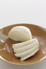 Sliced Mozzarella cheese and on dish 