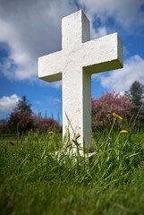 White Cross in Cemetery. A plain white cross marks a grave.

