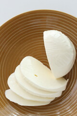 Sliced Mozzarella cheese and on dish 
