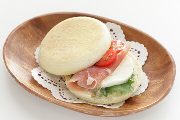 Homemade ham and Mozzarella cheese with herbal oba in English Muffin sandwich