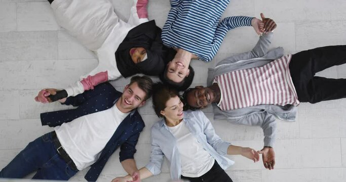 Group of happy young students showing unity