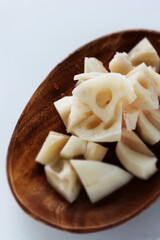 Chopped lotus root on wooden plate for prepared food ingredient