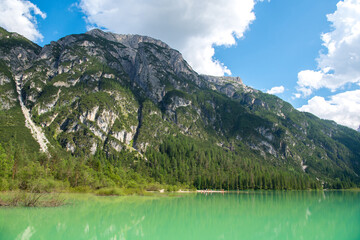 Mountains with alpine village on sunny summer day, the Dolomites Mountains, Italy
