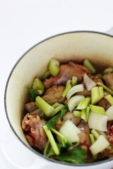 celery and onion with chicken in pot for stew cooking