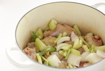 celery and onion with chicken in pot for stew cooking