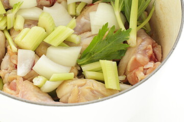 celery and onion with chicken in pot for stew cooking