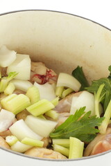 celery and onion with chicken in pot for stew cooking