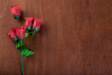 Fototapeta na wymiar A roses on the wooden Background