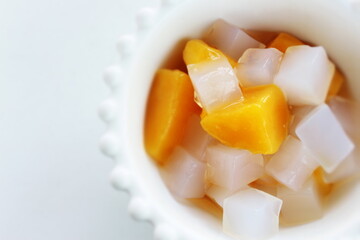 canned peach and Nata de coco in bowl for healthy dessert