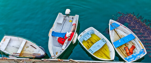 Fototapeta na wymiar Small Boats Tied Up at the End of Wharf in Monterey Bay, Monterey California, USA