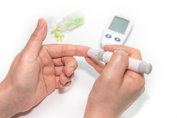 Diabetic woman taking blood sample with lancet pen