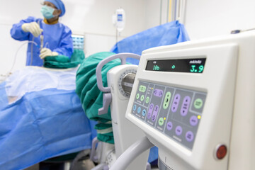 Close up photo of fluoroscope control screen inside modern operating room. Doctor in blue surgical...