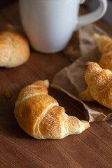 Fresh croissants on a wooden table
