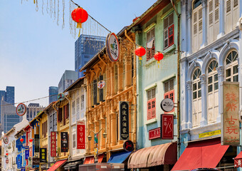 Facades of famous colorful colonial shop houses decorated with Chinese lanterns and fairy lights in...