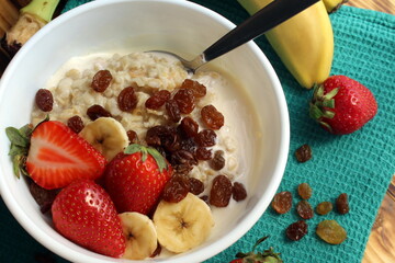 Oatmeal with fruits on a wooden table