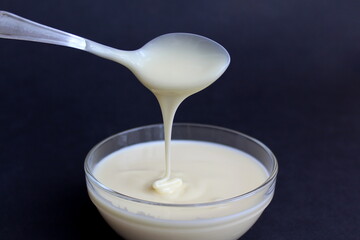 Condensed milk from a boat drains into a glass plate