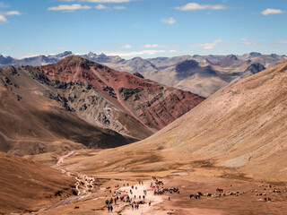 Picturesque landscape of the road that hundreds of tourists walk to reach the top of the rainbow mountain in Cusco, Peru.