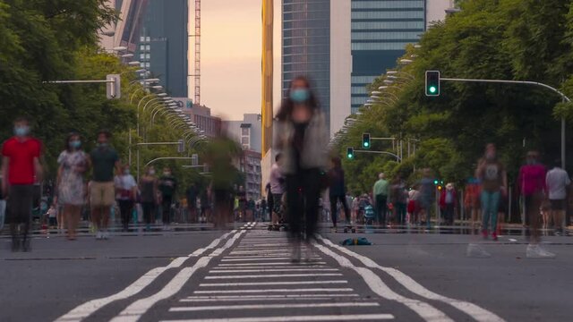 Close up Time lapse of Paseo de la Castellana in Madrid, Spain. People walking on the street covid 19. No cars in this major street because of Coronavirus outbreak.