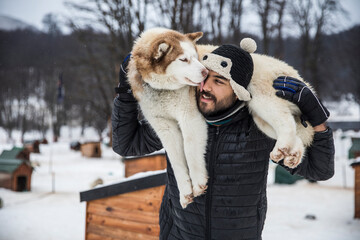 Man carrying a husky on his back