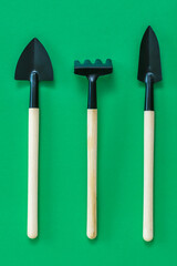 Hand tool for tillage on a green background.