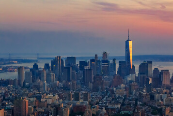 New York Downtown and lower Manhattan skyline view with the One World Trade Center skyscraper at sunset