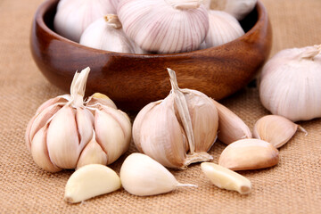 Garlic close-up on burlap background in studio. concept healthy lifestyle.