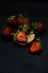 ripe strawberries berries on a black background selective focus frame blurring