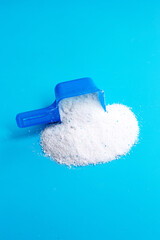 Detergent powder with measuring spoon  for clothes washing. Laundry concept.
