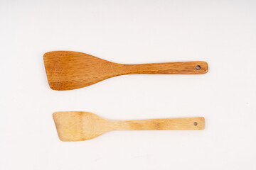 spade of frying pan made from wood on white background selective focus, kitchen flipper