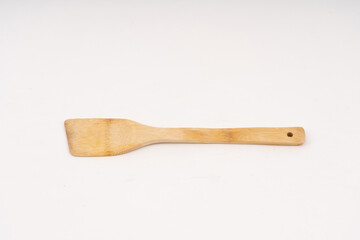 spade of frying pan made from wood on white background selective focus, kitchen flipper