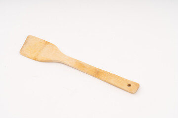 spade of frying pan made from wood on white background selective focus, kitchen flipper