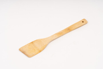 spade of frying pan made from wood on white background selective focus, kitchen flipper