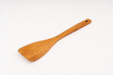 spade of frying pan made from wood on white background selective focus, kitchen flipper