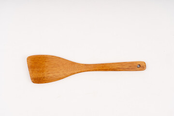 spade of frying pan made from wood on white background selective focus, kitchen flipper